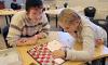 Child and youth care counsellor student plays Snakes'n'Ladders with a girl.