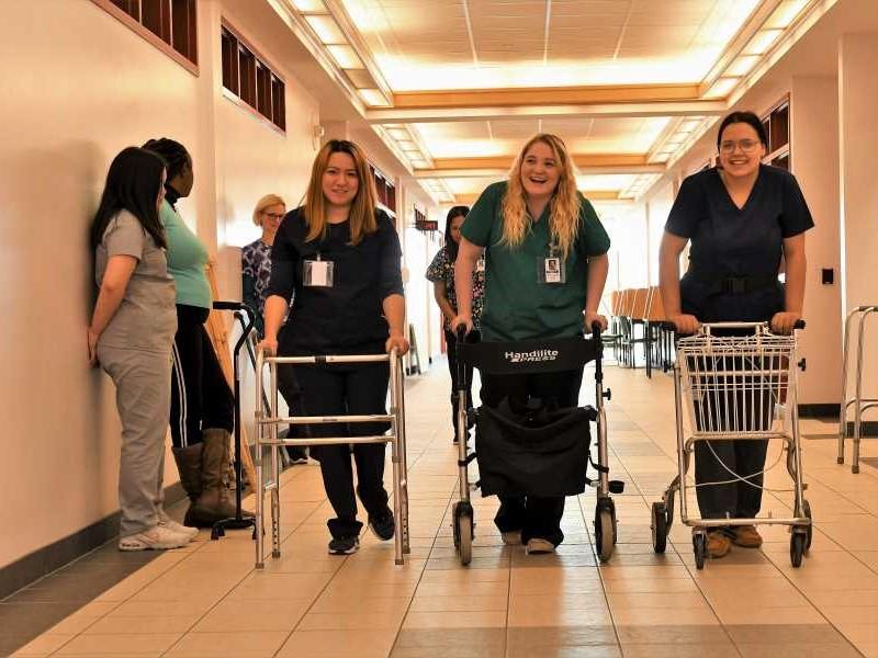 Health Care Aide students trying walking aids.